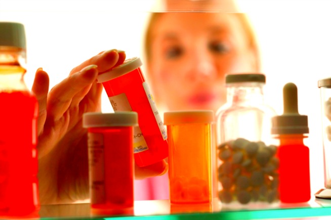 young-woman-looking-in-medicine-cabinet